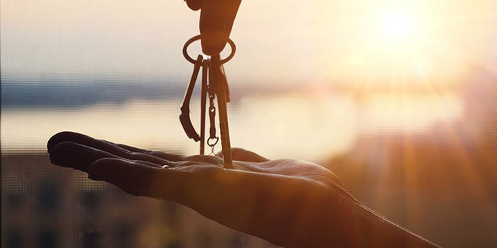 A person hands keys to another person