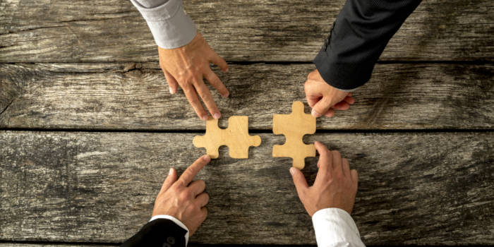 Two puzzle pieces being joined.
